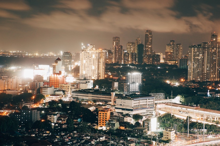 A vibrant cityscape of Mumbai at night, illuminated by countless lights, creating a mesmerizing view.