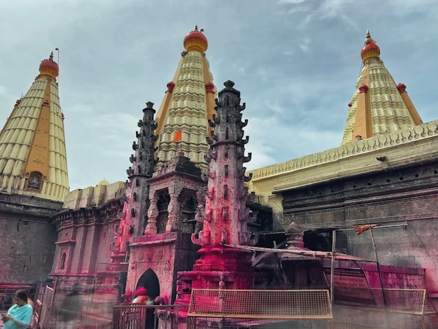 A vibrant Hindu temple in India, adorned in pink hues, showcasing the rich cultural heritage of the country.