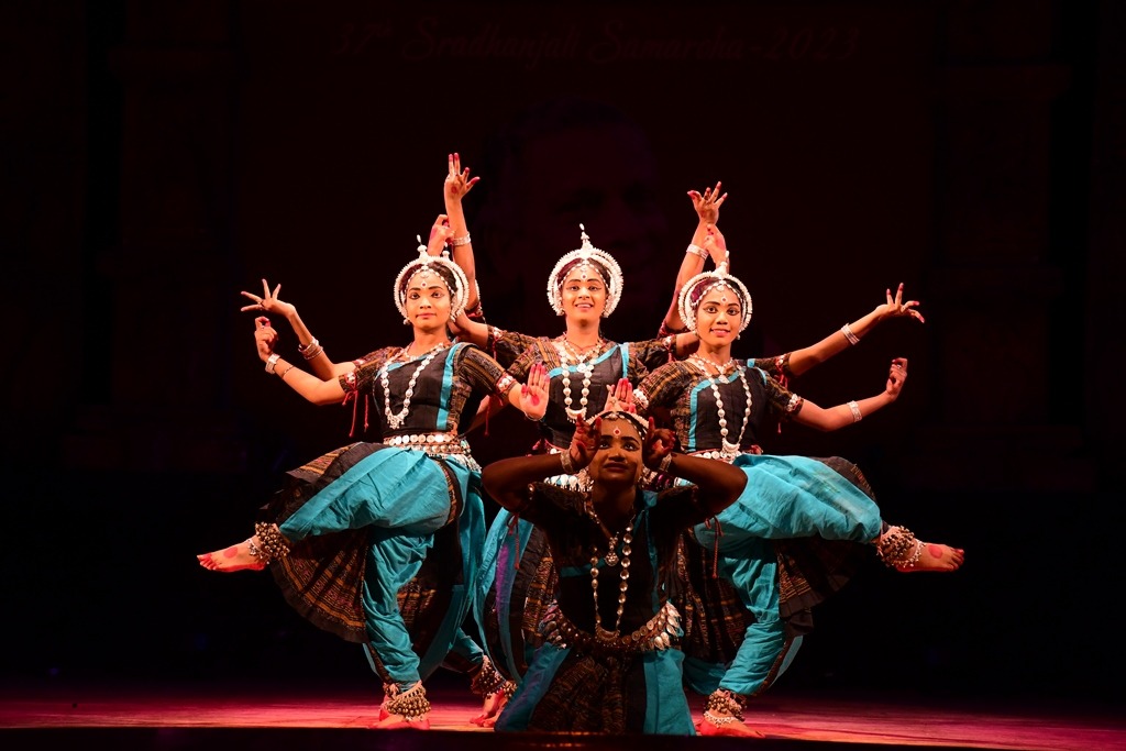 Women dancing gracefully on stage during a performance.