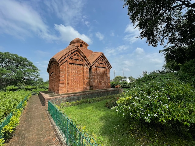 Old Terracotta Temple in green surroundings under the blue sky