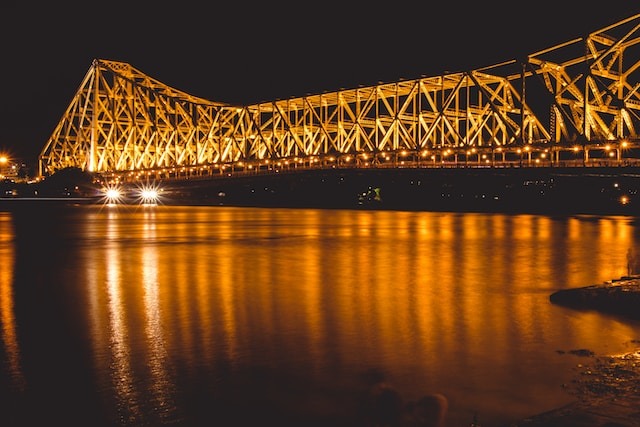 Scenic view of a tranquil river with light reflecting on the water from the bridge