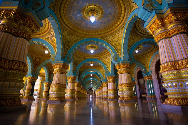 Interior of grand building with blue and gold decor.