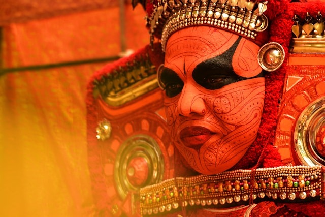 A man in a vibrant red and gold costume, exuding elegance and power.