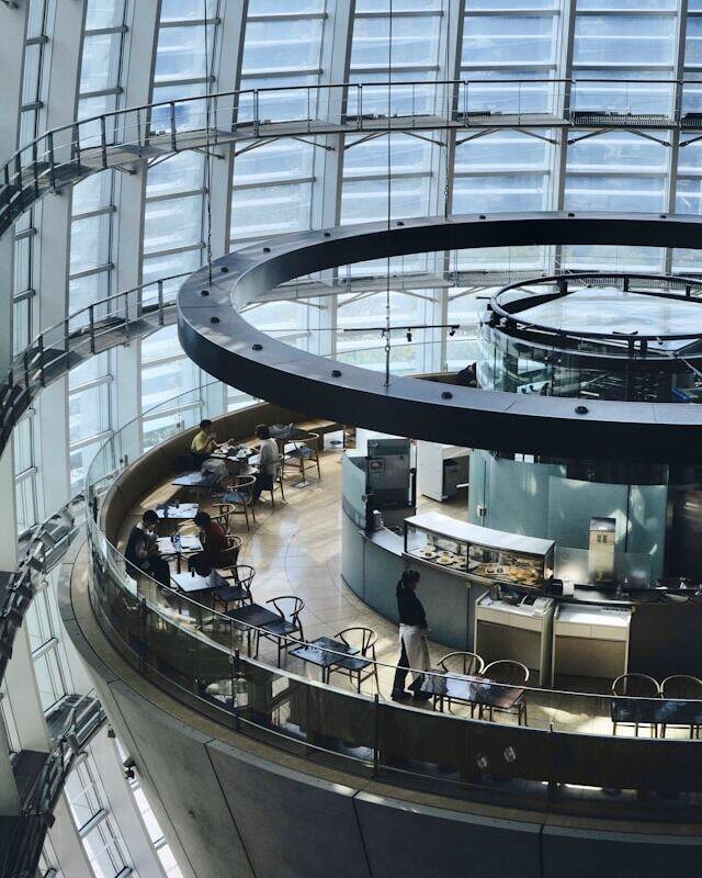 Interior of building with circular glass ceiling, allowing natural light to illuminate the space.