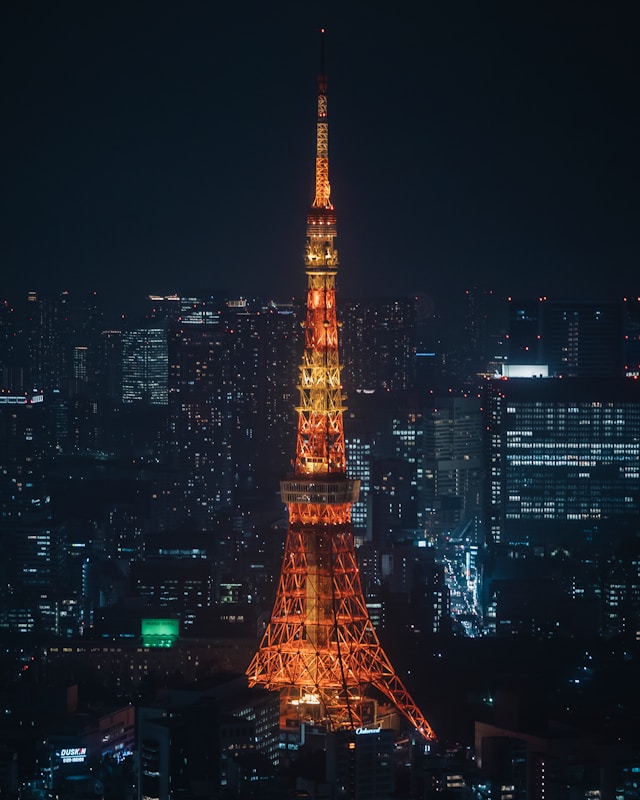 Illuminated Tokyo Tower shining brightly against the night sky in Tokyo, Japan.