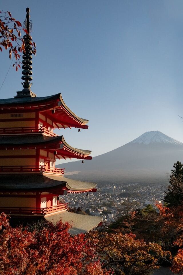 Mount Fuji in autumn, showcasing vibrant foliage against the majestic peak, creating a picturesque landscape.