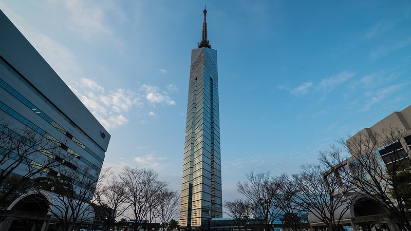 Aerial view of a tall building against a clear blue sky.