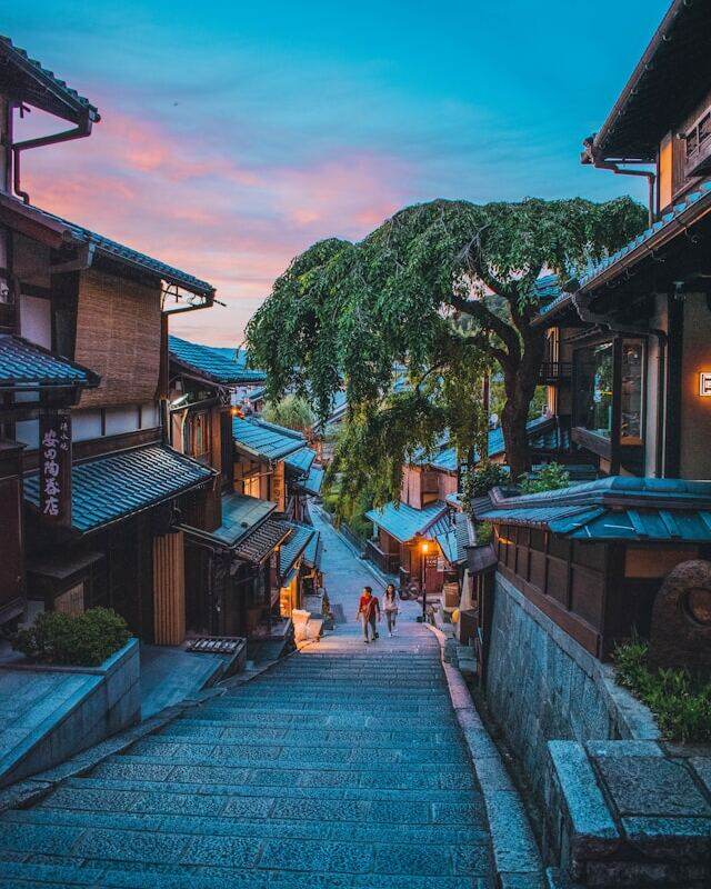 A serene street in Kyoto, Japan, bathed in the warm hues of a sunset.