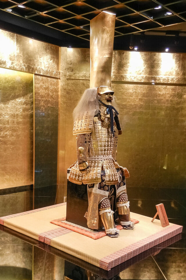 A museum exhibit showcasing a samurai statue, representing the rich history and culture of Japan.