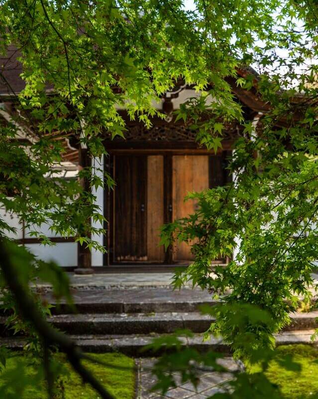 Entrance of Ryoanji temple surrounded with lust green plantation.