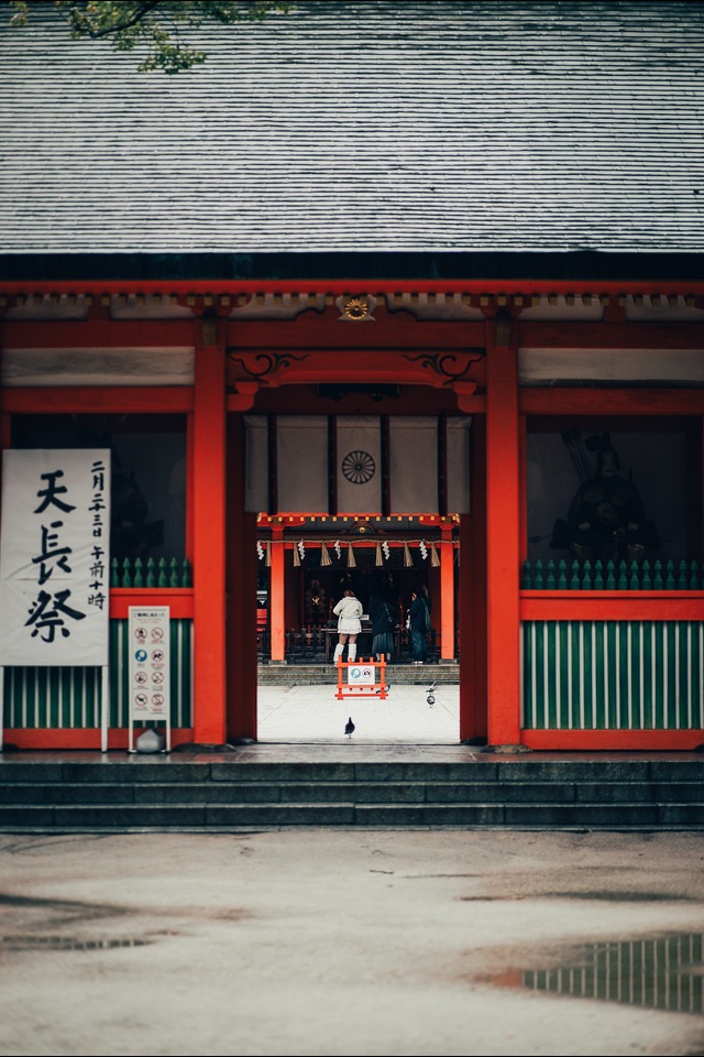 A person walking through a modern red and white building.