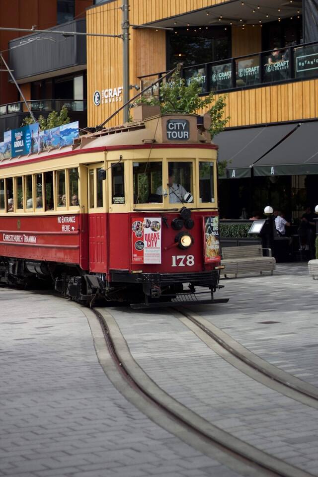 A vintage trolley car painted in red and white, showcasing its classic charm and transportation history.