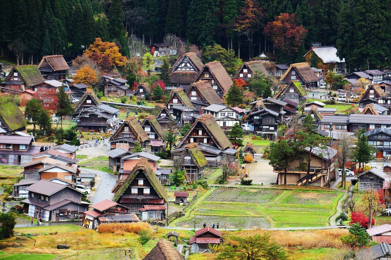 A picturesque mountain village with numerous houses nestled amidst the scenic beauty.